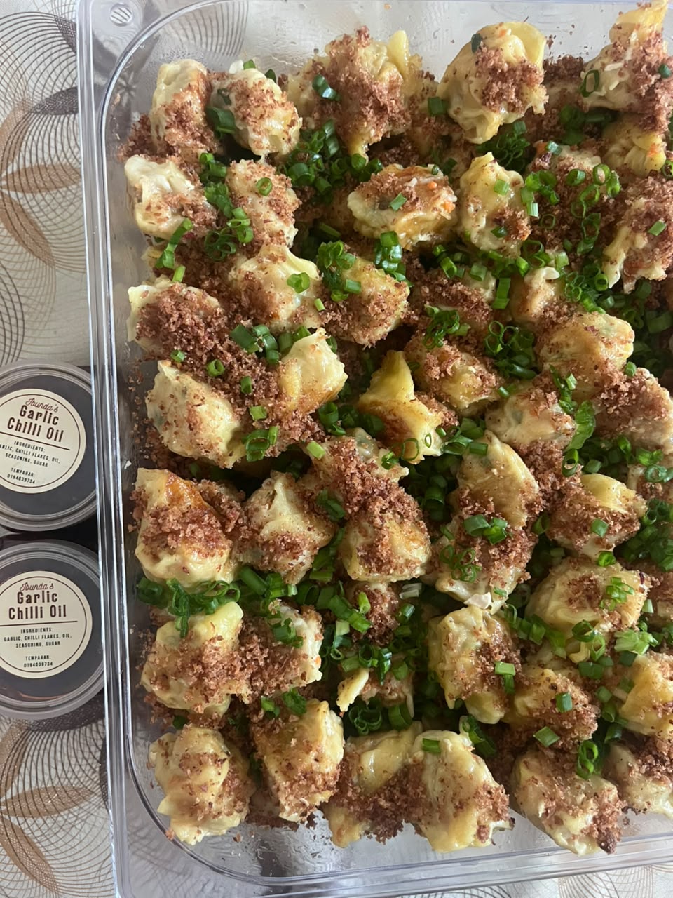 Fifty chicken dumplings in a large tray